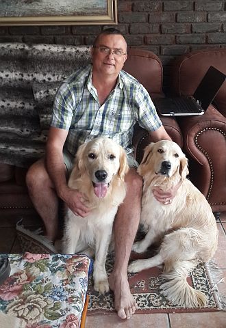 Andre with 2 golden retrievers.